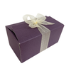 A ballotin with ribbon filled with candied orange peels coated with 70% gluten-free, vegan dark chocolate, handmade by our confectioner Léonard Parli in Aix-en-Provence.