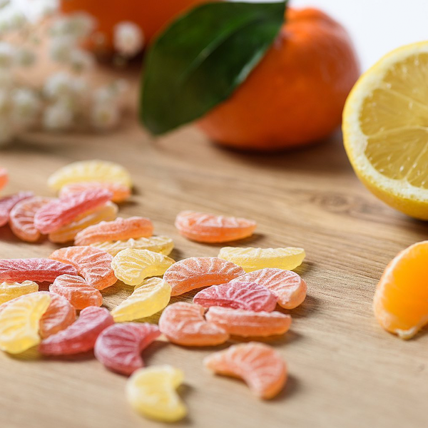 Opened bag of 250g of bulk CDHV's 100% natural fruit quarters frosted candies.
