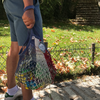 Blue-red-white Filt 1860's net shopping bag in someone's hands, with groceries in it