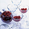 Coupes glasses for griottines Peureux, with some griottines in some of them and a jar of griottines opened