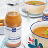 Bottle of La Perle des Dieux' langoustine bisque with some served in bowls.