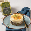 La Perle des Dieux' tin of sardines with sliced olives and rosemary in the background, with a recipe made with them on a plate in the foreground.