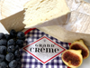 Slices of Grand Crème cheese with blueberries and figs.