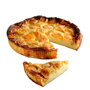 Apricot clafoutis with one slice cut.