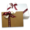 Gift boxes closed and ornamented with Douce France satin ribbon