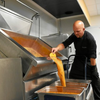 Our supplier l'Ambr'1 busy preparing caramel at their workplace.