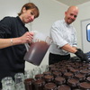 Our supplier l'Ambr'1 busy filling up their jars of caramel at their workplace.