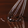 A whisk with a chocolate preparation