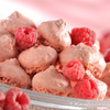 Fossier's raspberry macarons on a dish with fresh raspberries.