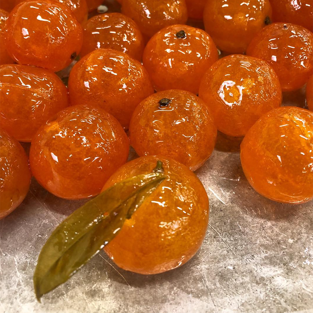 Freshly candied clementines at Corsiglia's workplace.