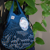 Aquarius blue Filt 1860's net shppoing bag, hung with clothes inside