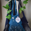 Filt 1860's net shopping bags hung near a plant