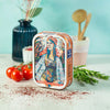 Tin of La Perle des Dieux' 2021 vintage sardines displayed with tomatoes and herbs