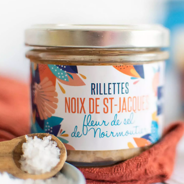 La Perle des Dieux' jar of 2022 award winner scallop rillettes with Noirmoutier fleur de sel, with some fleur de sel in a spoon in the foreground.