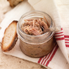 Jar of rillettes opened with toast on the side