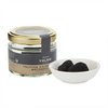 A jar of Artisan de la Truffe Paris' extra whole black truffles with two in a bowl in the foreground. Net weight: 15g